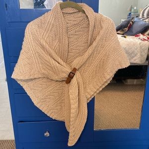 Cozy cream-colored poncho with cool brown leather closure